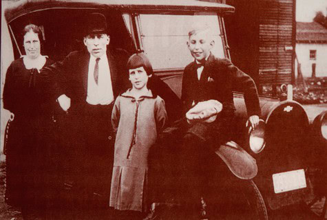 Vintage black-and-white photo of a family standing beside a car in Lodi wine country.