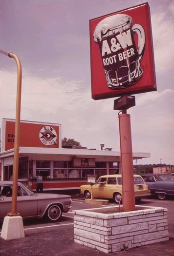 A&F Root Beer sign outside Lodi Winegrape Commission building with vintage cars in parking lot.
