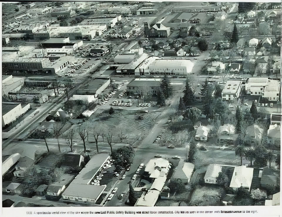 Aerial view of Lodi, California, showing vineyards, buildings, and streets in a rural-urban landscape.