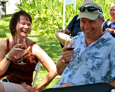 People enjoying wine tasting outdoors at a Lodi Winegrape Commission event.