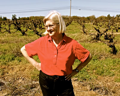 Woman in red shirt touring a vineyard in Lodi, California, during the day.