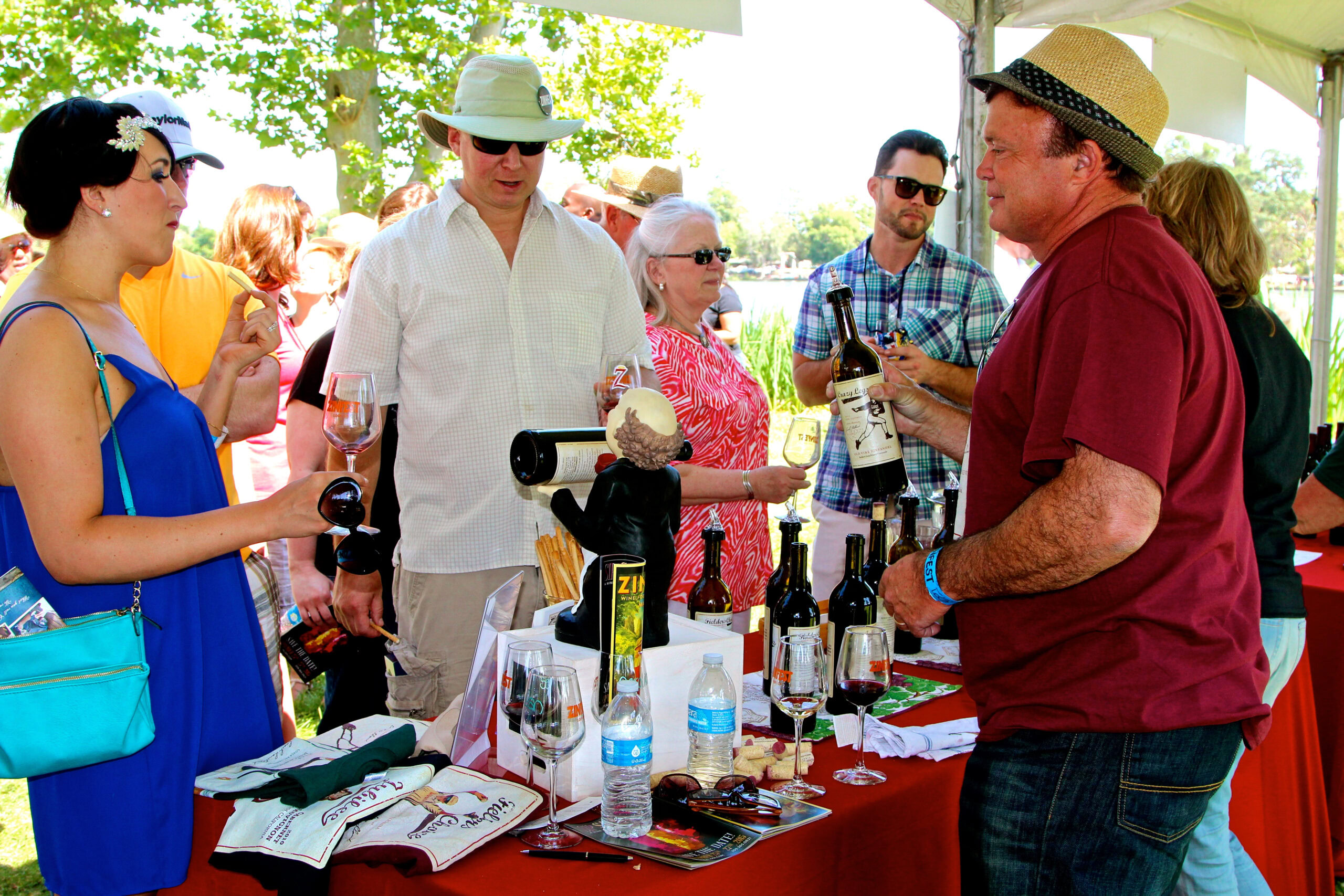 People enjoying wine tasting at an outdoor event organized by the Lodi Winegrape Commission.