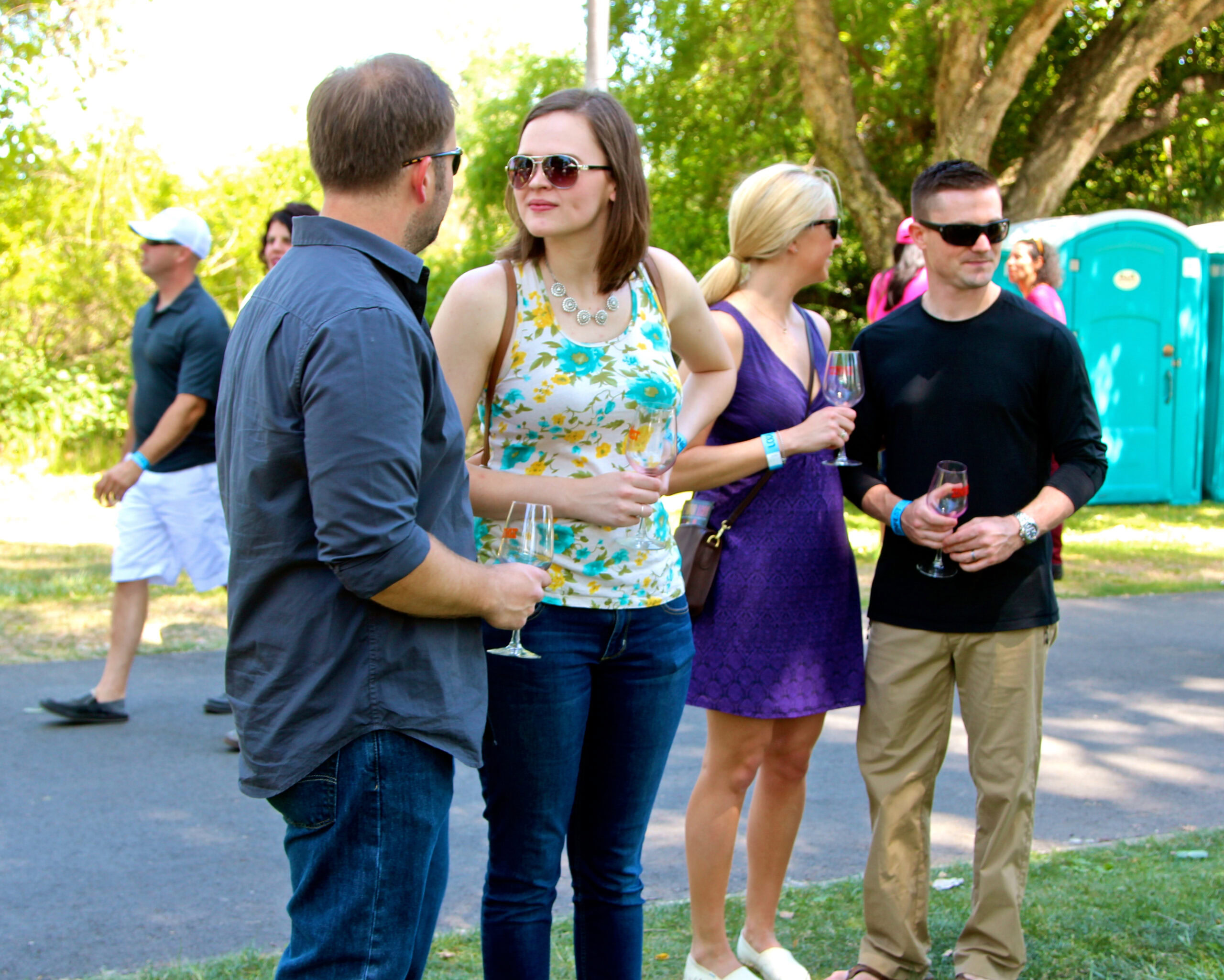 Group of people enjoying wine tasting outdoors at a Lodi Winegrape Commission event.