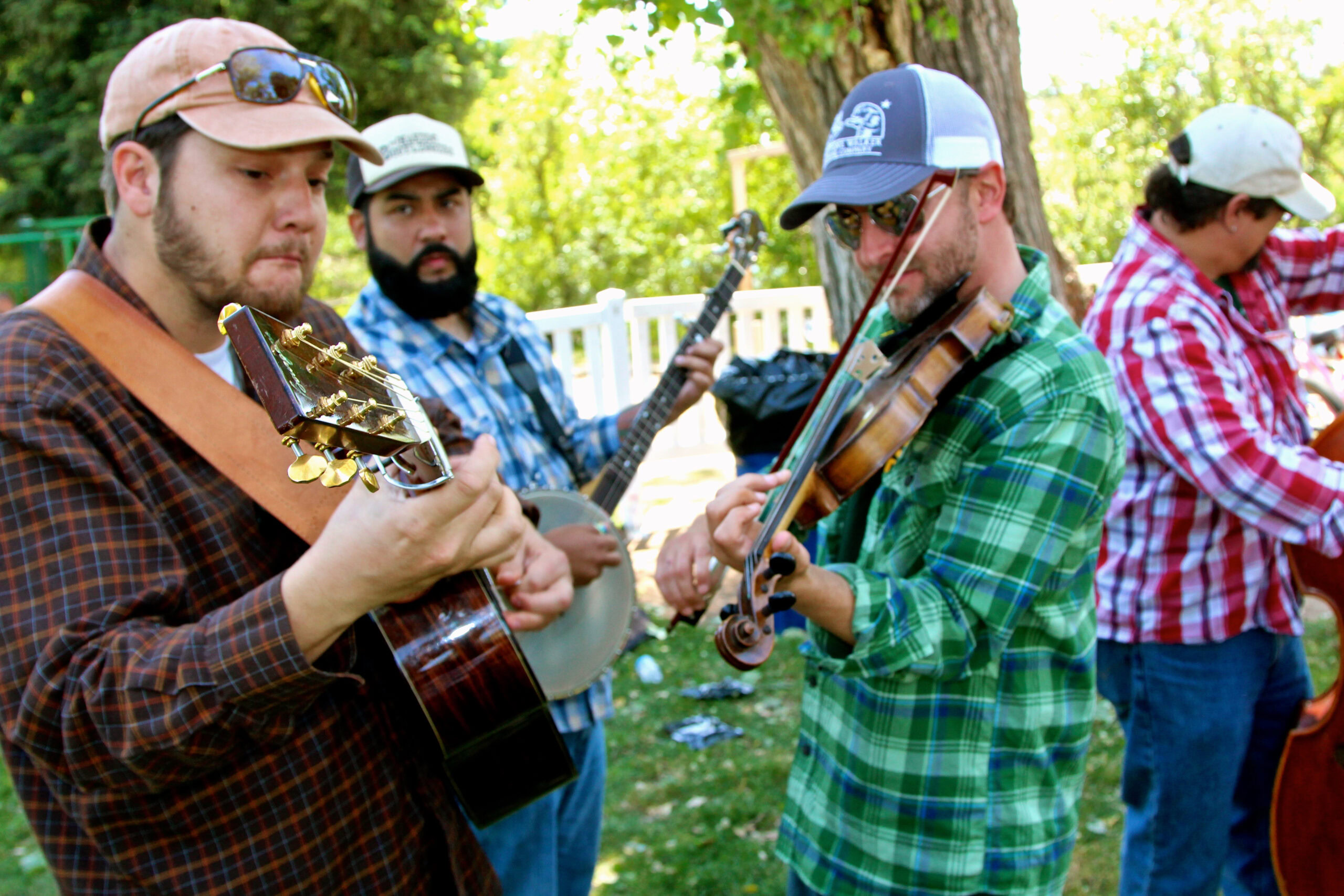 Group of musicians playing guitar and violin outdoors at Lodi Winegrape Commission event.