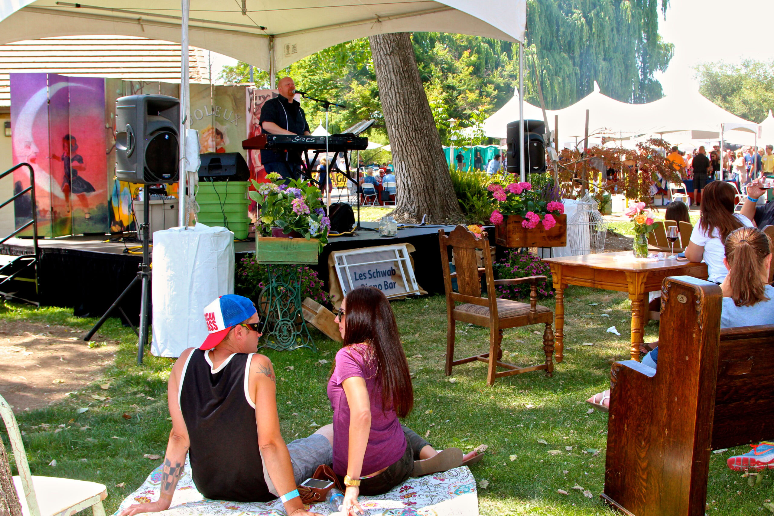 Live music performance at a Lodi Winegrape Commission outdoor event with audience and vendors.