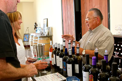 Wine expert explaining wine varieties at Lodi Winegrape Commission tasting event.