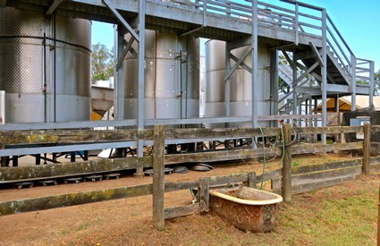 Vineyard irrigation system with tanks and wooden fence at Lodi Winegrape Commission.