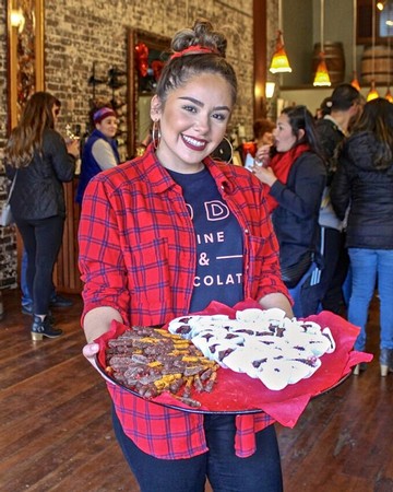 Young woman holding a tray of assorted cookies at a Lodi Winegrape Commission event.
