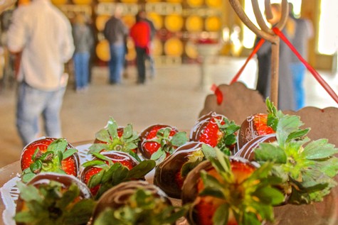 Fresh strawberries with green leaves at the Lodi Winegrape Commission event, showcasing local produce and agriculture.