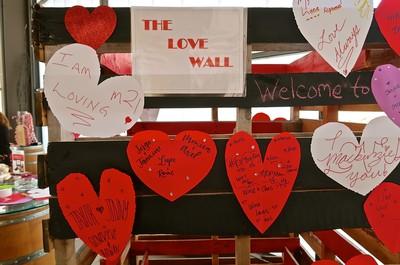Colorful love wall with handwritten notes and hearts at Lodi Winegrape Commission event.