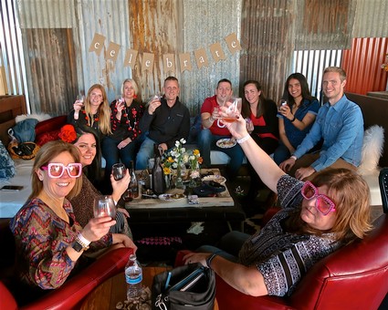 Group of people celebrating with wine at Lodi Winegrape Commission event, smiling and enjoying the moment.