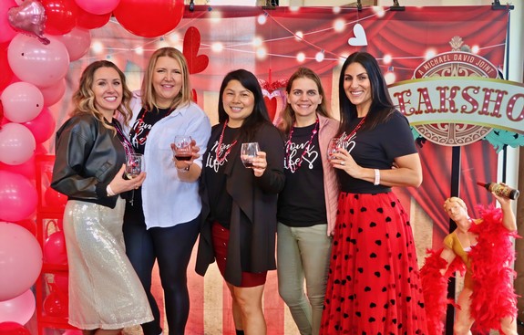 Group of women celebrating at Lodi Winegrape Commission event with balloons and decorations.