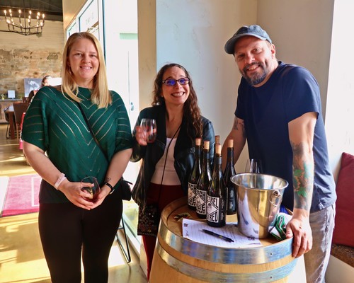 Group of people enjoying wine tasting at Lodi Winegrape Commission event.