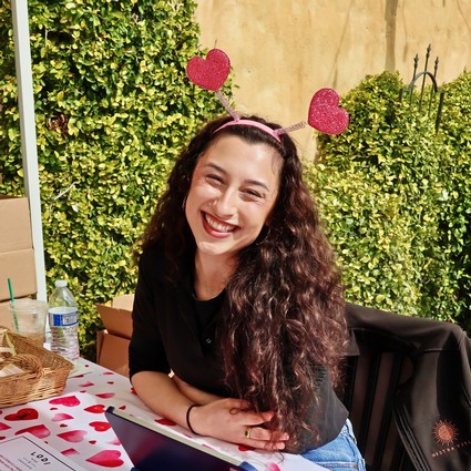 Smiling woman with heart-shaped headband at Lodi Winegrape Commission event.