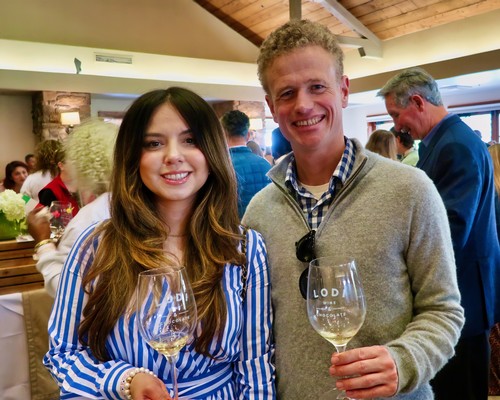 Smiling man and woman holding wine glasses at Lodi Winegrape Commission event.