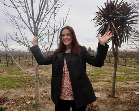 Happy woman in a vineyard during a tour at Lodi Winegrape Commission, California.
