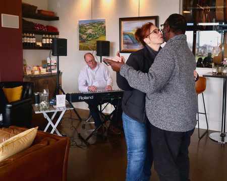 Couple dancing at Lodi Winegrape Commission event with live music in the background.