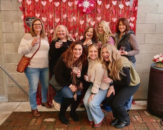 Group of women celebrating with wine glasses at Lodi Winegrape Commission event.