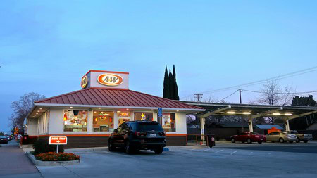 A&W fast food restaurant with parking lot and cars in Lodi, California, during evening hours.