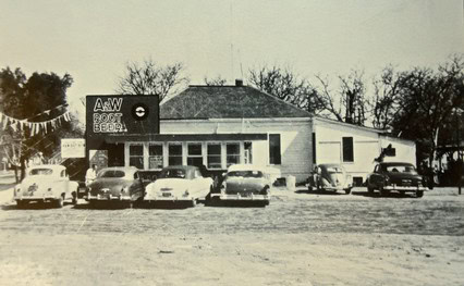 Historic black and white photo of the Lodi Winegrape Commission building with vintage cars parked in front.