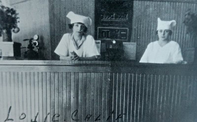 Black and white vintage photo of two women at a wine tasting event for Lodi Winegrape Commission.