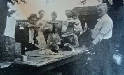 Vintage photo of farmers and workers harvesting grapes in Lodi, California, early 20th century.