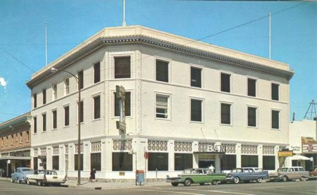 Historic Lodi Winegrape Commission building in downtown Lodi, California, with vintage cars parked outside.
