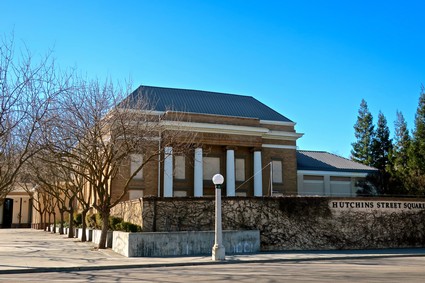Historic building with columns and trees in Hutchins Street Square, Lodi, California.