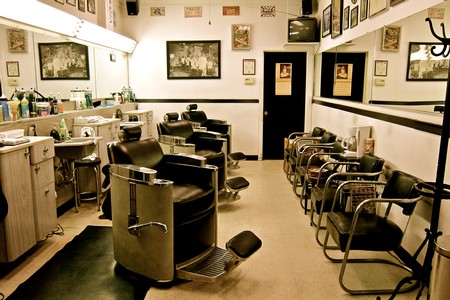 Interior of a salon with black chairs, mirrors, and wine-themed decor, promoting Lodi Winegrape Commission.
