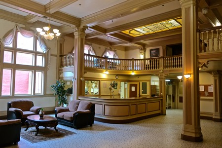 Elegant hotel lobby with vintage decor, large windows, and cozy seating in Lodi wine country.