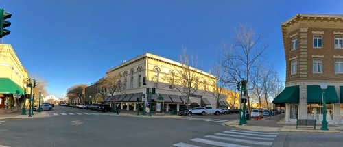 Street view of the Lodi Winegrape Commission building in downtown Lodi, California, with clear blue sky and surrounding shops.