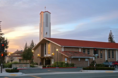 Lodi Winegrape Commission building at sunset with church tower and trees in the background.