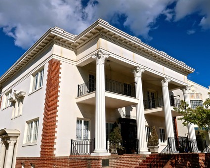 Historic building with white columns and red brick accents in Lodi, California, representing the wine industry.