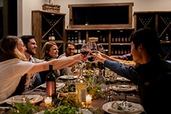 Group of people enjoying wine tasting and toasting at a winery event in Lodi, California.