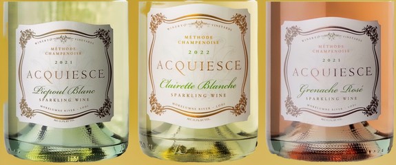 Three bottles of Acquiesce sparkling wines from Lodi Winegrape Commission, showcasing different flavors and labels.
