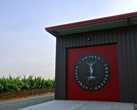 Lodi Winegrape Commission building with vineyard in the background, showcasing local wine industry.