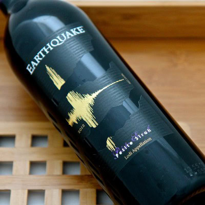 Earthquake wine bottle from Lodi Winegrape Commission with mountain landscape label.