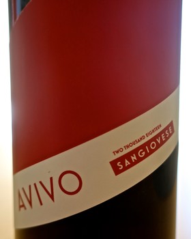 Close-up of a Sangiovese wine bottle from Lodi with a red and white label.