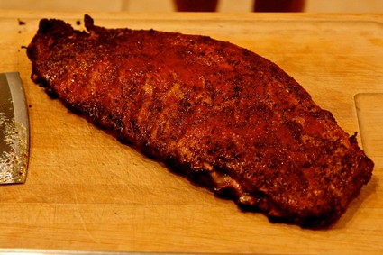 Juicy, seasoned grilled steak on a wooden cutting board, perfect for wine pairing and culinary enjoyment.