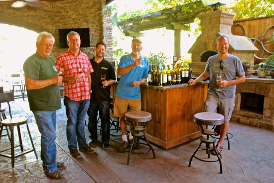 Group of men enjoying wine tasting at Lodi Winegrape Commission event.