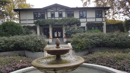 Elegant office building of the Lodi Winegrape Commission surrounded by lush gardens and a fountain.