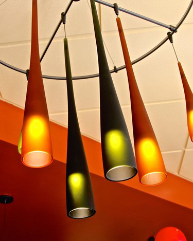 Colorful modern pendant lights hanging from ceiling, decorative lighting fixture for contemporary interior spaces.