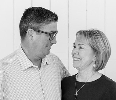 Two people smiling and talking, representing community engagement in Lodi Winegrape Commission.