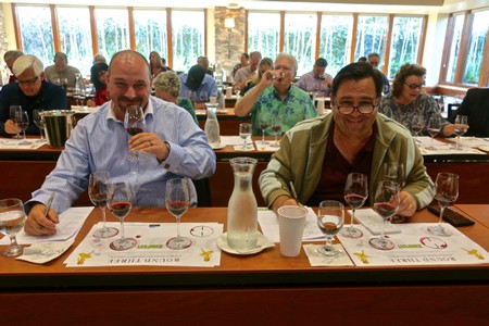 People enjoying wine tasting at a Lodi Winegrape Commission event in a bright, scenic winery setting.