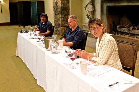 People tasting wine at a panel discussion organized by the Lodi Winegrape Commission.