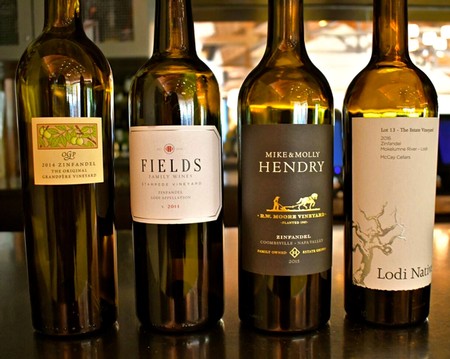 Four wine bottles from Lodi Winegrape Commission showcasing Zinfandel and other varietals.