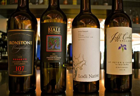 Four wine bottles from Lodi Winegrape Commission showcasing local vineyards and varietals.