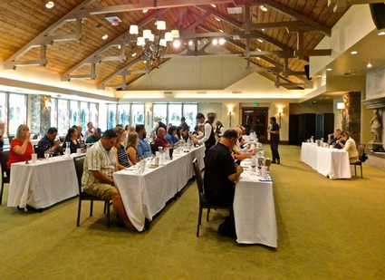 Attendees at a wine tasting event organized by the Lodi Winegrape Commission in a spacious, well-lit venue.