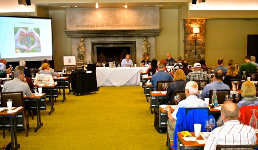 Attendees at a Lodi Winegrape Commission event listening to a presentation in a conference room.