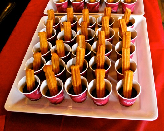 Tasting samples of wine with wooden sticks in small cups at Lodi Winegrape Commission event.